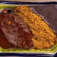 Mojarra Adobada · Fried tilapia marinated in chipotle sauce accompanied with rice, black beans & 5 homemade to...