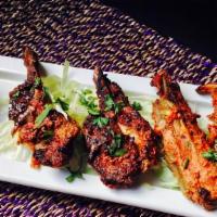Lamb Chops · Frenched lamb chops marinated with herbs, spices and grilled in a clay oven