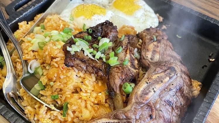 Boka Steak & Eggs · BBQ short ribs over kimchi fried rice and TWo eggs sunny-side up.