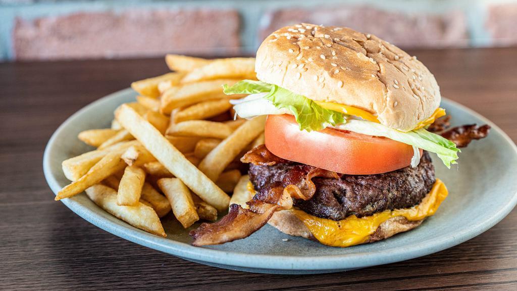 Beef Burger Deluxe · Includes lettuce, tomato, cheese and choice of one topping and one sides.