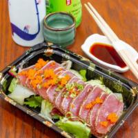 Pepper Tuna Tataki · 8 pieces. Seared pepper tuna and scallions, with onion radish.