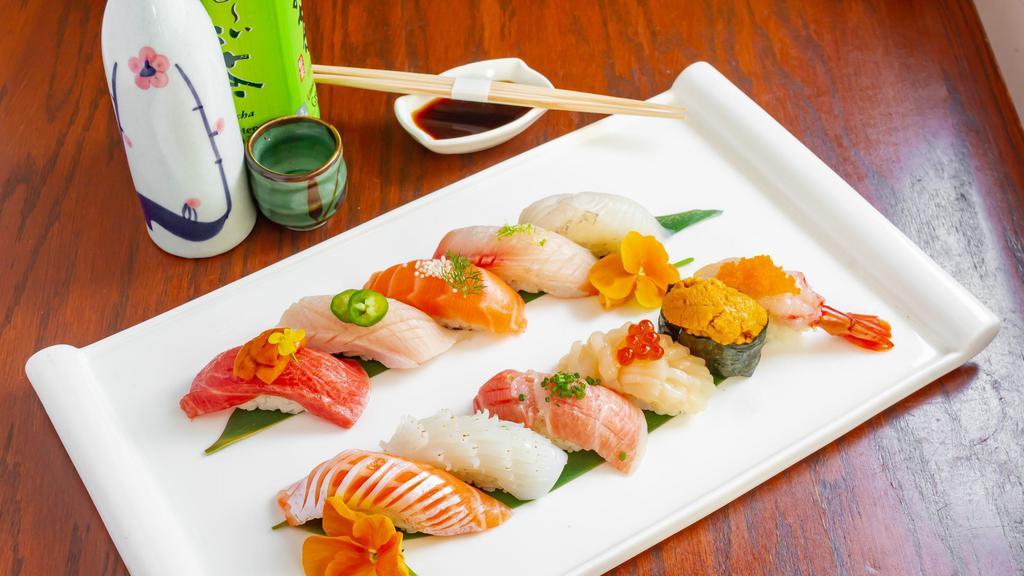 Sushi Deluxe   · Chef choice of 12 pieces sushi with one California roll or Tuna Roll, or Salmon Roll. Served with soup and salad.