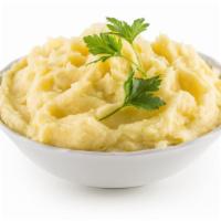 Mashed Potatoes · Boiled mashed potatoes prepared with milk, butter, salt and pepper.