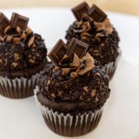 Death By Chocolate Cupcake · Chocolate cake filled and topped with chocolate buttercream, and decorated with chocolate cr...