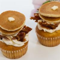 Maple Bacon Cupcake · Maple infused cake filled and topped with vanilla buttercream, with maple syrup, crispy baco...