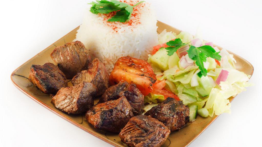 Grilled Lamb & Rice · Juicy piece of lamb marinated to perfection, served over a steaming bed of rice, a side of veggies and your choice of sauce.