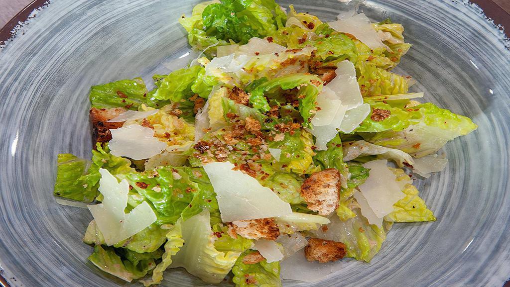Caesar Salad · Fresh romaine lettuce, tossed with Parmesan cheese and Caesar dressing, topped with croutons. Add chicken at an upcharge.