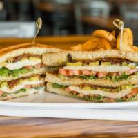 Chicken Avocado Club · Oven roasted chicken, fresh avocado, tomatoes, bacon, Provolone cheese and mayo on toasted s...