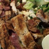 Cobb Salad · Grilled chicken, bacon bits, boiled egg, avocado tomato, onion, feta cheese, ranch.