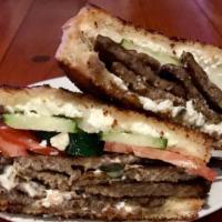 Triple G - Grilled Greek Gyro · A twist on a traditional Greek gyro, with lamb & beef gyro meat, cucumbers, tomato, onions, ...