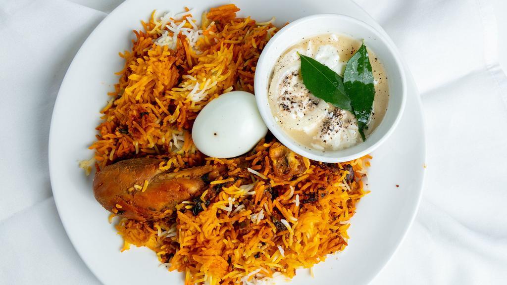 Chicken Biriyani · Aromatic combination of saffron, cashew nuts, raisins and herb-flavored rice. Served with a fried egg and a fried Chicken Leg.