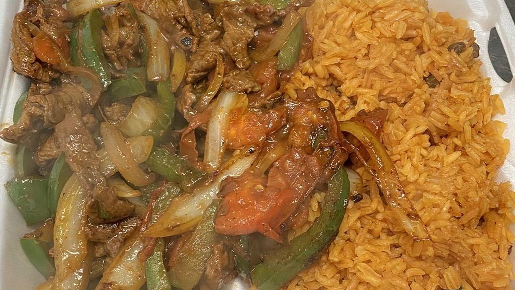 Fajitas Steak Or Chicken · Bell pepper and onions and tomato served with your choice of chicken, or steak.