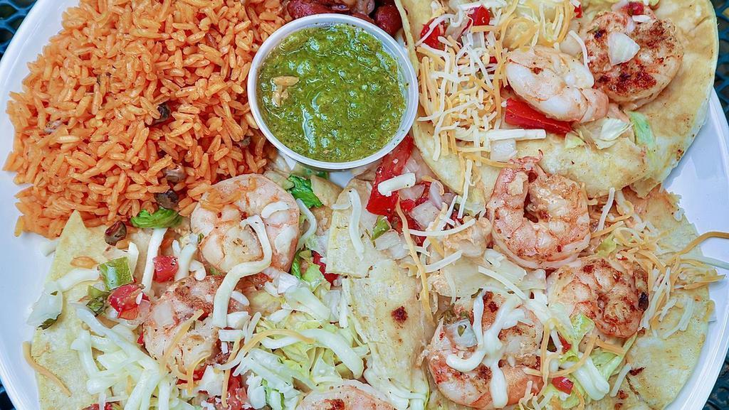 Shrimp Taco/  Tacos De Camaron · Three shrimp taco choice of flour or corn tortilla, lettuce, and a special sauce.
Served with a side of rice, beans and salsa.