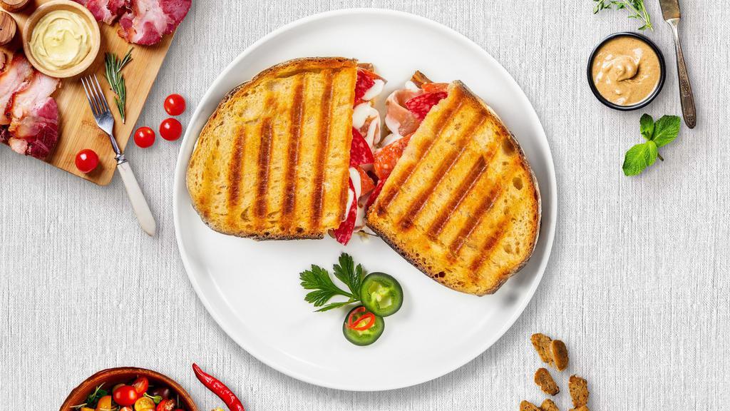Italiano Panini · Grilled chicken, mozzarella cheese, roasted peppers, and pesto sauce on toasted bread.