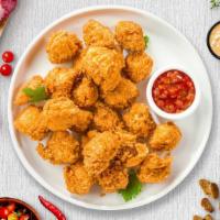 Chicken Popcorn · Bite-size pieces of chicken breaded and fried until golden brown.