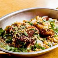 Aloo Tikki Chaat · Potato patties served with curried chickpeas topped with mint chutney, tamarind chutney, and...