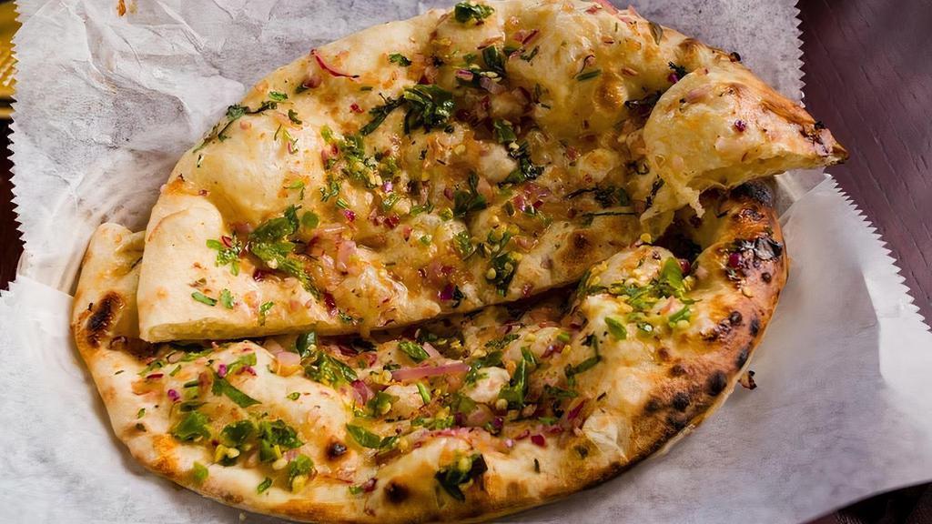Chili Onion Naan · Tandoor fired white flour bread with chili and onion