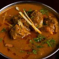 Patiala Goat Curry · Punjabi style curry, onions, and tomatoes.