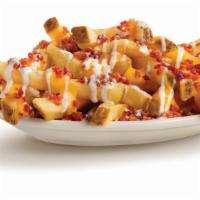 Ultimate Fries · Topped with cheese sauce, bacon pieces and ranch dressing.