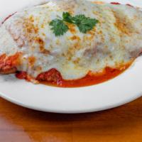 Chicken Parmigiana · Breaded chicken cutlet with mozzarella & tomato sauce