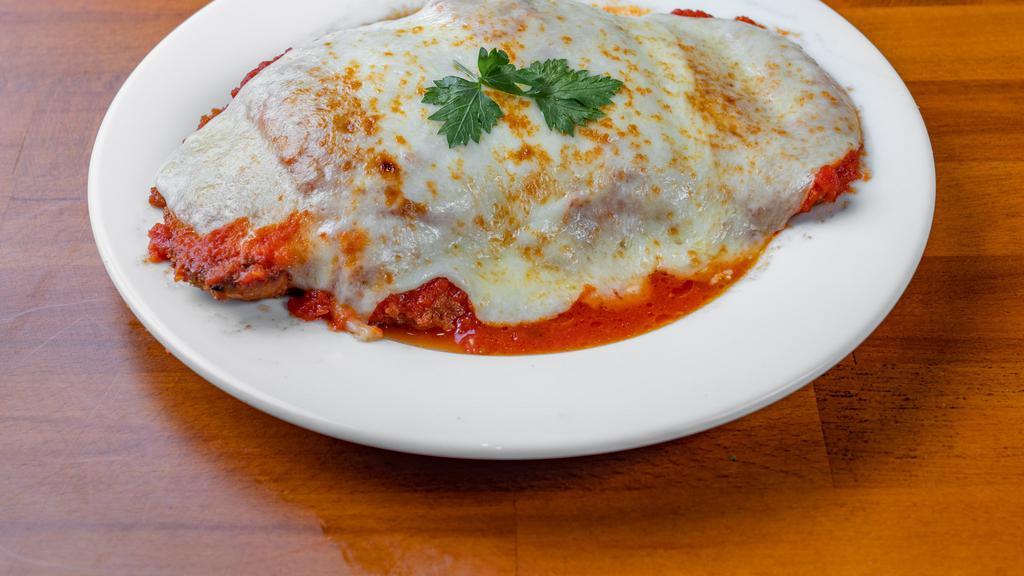 Chicken Parmigiana · Breaded chicken cutlet with mozzarella & tomato sauce