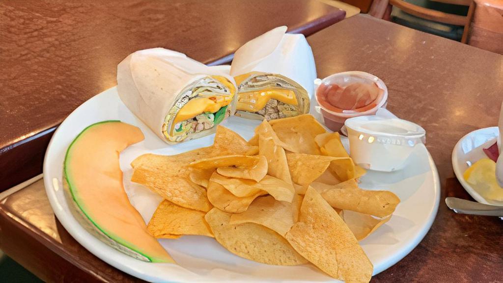Breakfast Burrito · Scrambled eggs, grilled chicken, peppers, onions & cheese wrapped in a grilled flour tortilla, served with tortilla chips, sour cream & salsa.