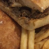 Philly Style Cheese Steak · Grilled sliced steak with onions & melted Swiss on hero bread.