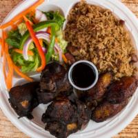 Jerk Chicken · Served with black rice and peas white rice and fried green or sweet plantain.