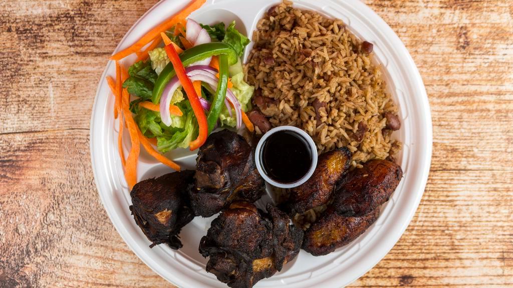 Jerk Chicken · Served with black rice and peas white rice and fried green or sweet plantain.