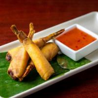 Shrimp Roll · Whole shrimp stuffed with minced chicken wrapped in fried paper-thin spring roll crape serve...