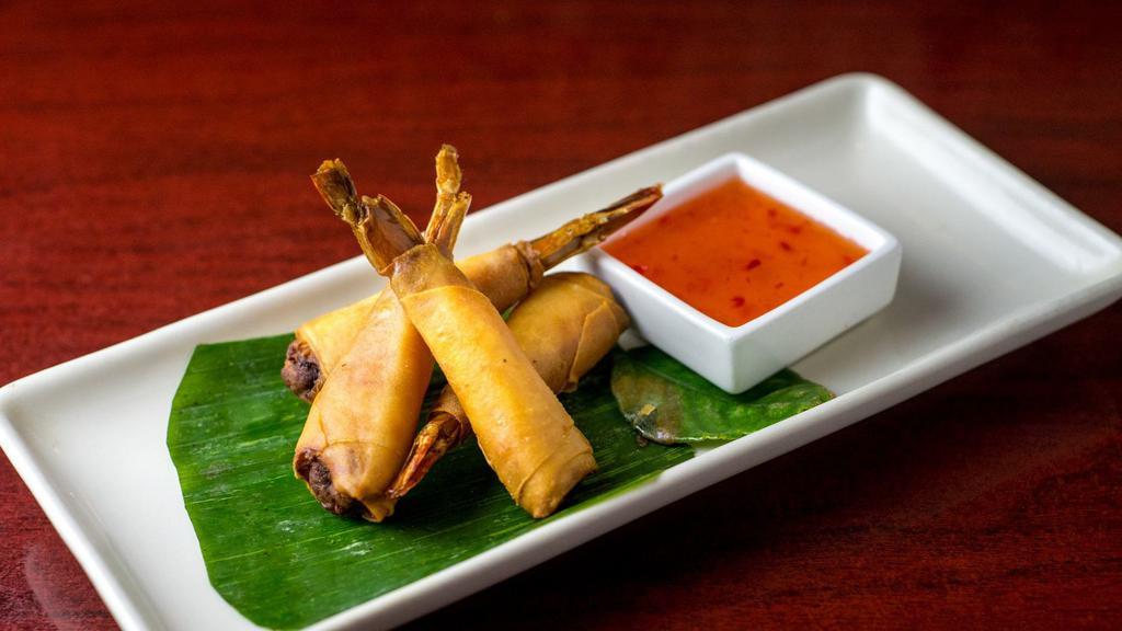Shrimp Roll · Whole shrimp stuffed with minced chicken wrapped in fried paper-thin spring roll crape served with plum sauce.