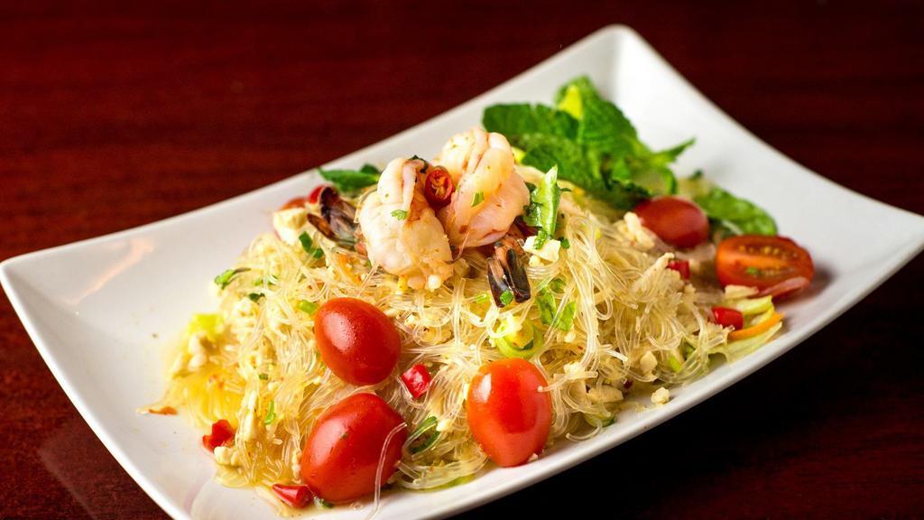Glass Noodle Salad (Yam Woon Sen) · Little spicy. Vermicelli noodle, shrimp,calamari, minced chicken, tomato, onion, chili, mints, mixed greens, lime dressing.