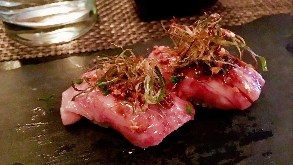 Miyazaki Beef Strip-Loin Sushi (A5) · Topped with white truffle soy,deep fried garlic,chives and deep fried tokyo negs.