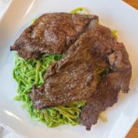 Tallarin Verdes Con Bistec · Spaghetti in a basil cheese sauce with beef.