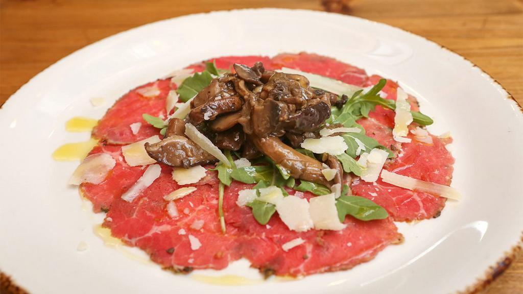 Carpaccio Di Manzo · Thinly sliced beef tenderloin, mushrooms, arugula, and Parmesan cheese.