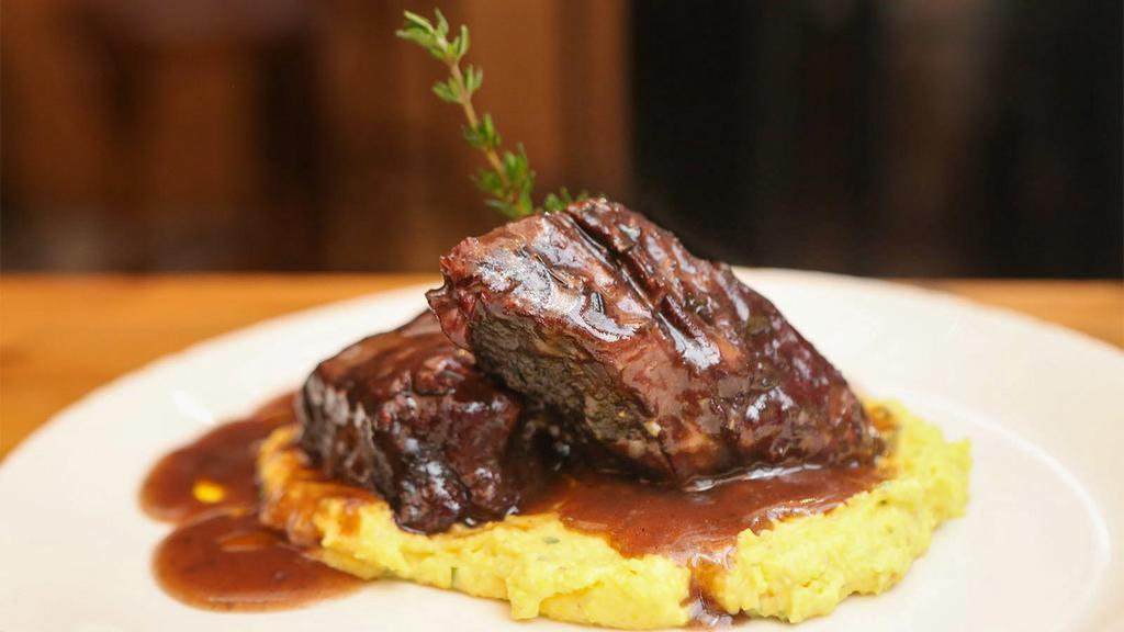 Costine Di Bue · Braised beef short ribs served with soft polenta.