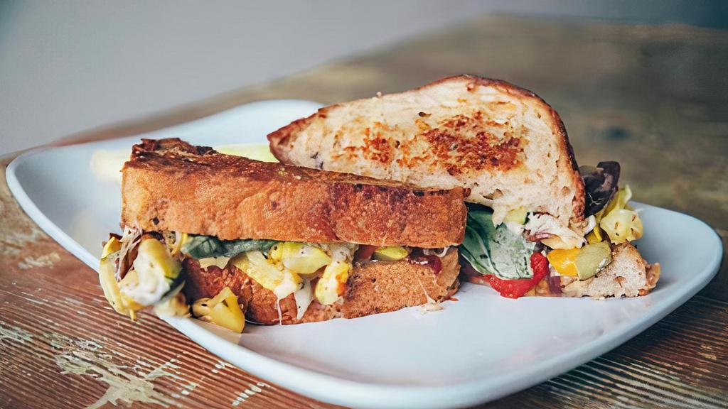 Grilled Veggie Sandwich · Multi-grain, zucchini, yellow squash, eggplant, red and yellow peppers, balsamic red onion, basil, and mozzarella cheese.