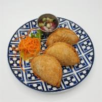 A-9 Curry Puffs · Curry flavored chicken, potato and onion in crispy puff pastry, served with cucumber relish....