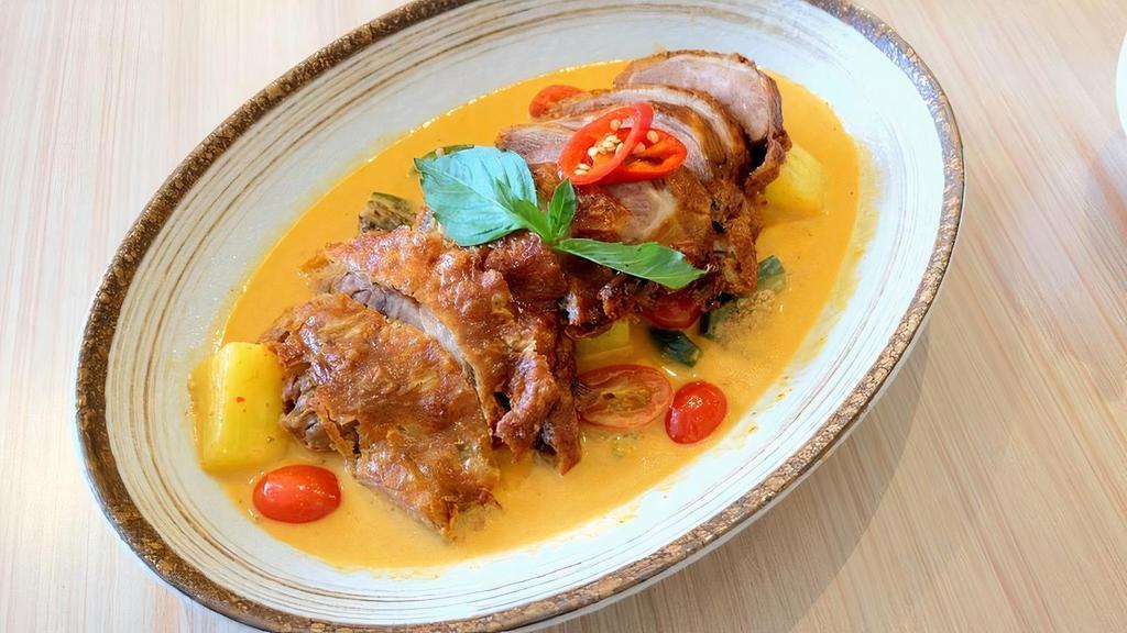 M-10 Lychee Duck Curry · Half crispy roasted duck with lychee, pineapple,  tomato, string bean, bell pepper, and basil in red curry sauce. **If you need plastic utensils, please request.**