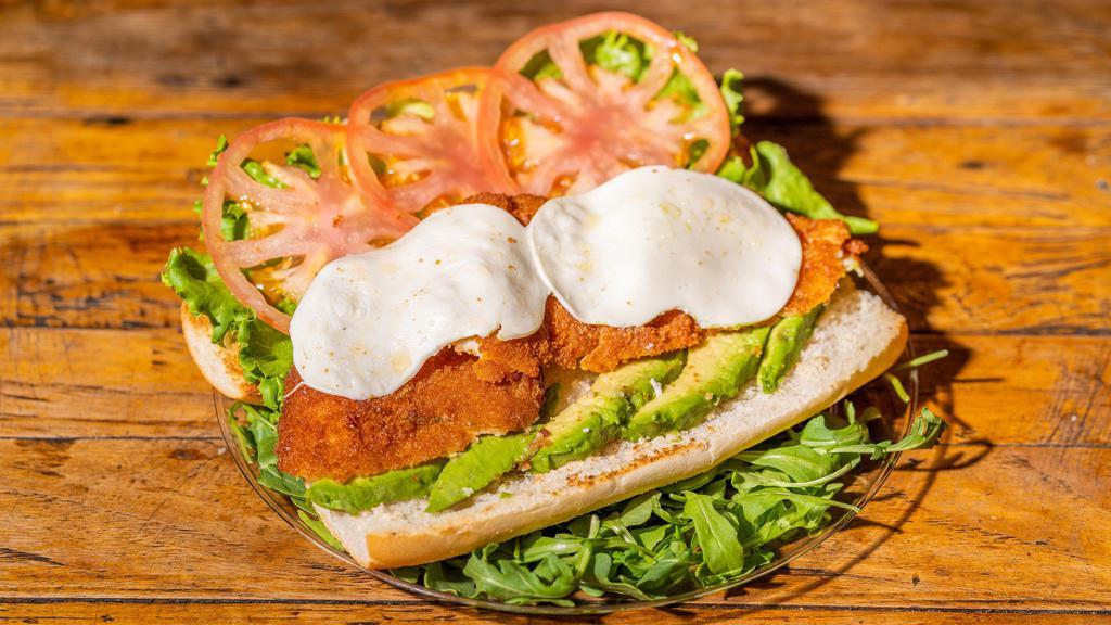 Crispy Chicken Sandwich · Crispy chicken cutlet with fried tropical cheese, shredded lettuce, and sweet ripe tomato and avocado.