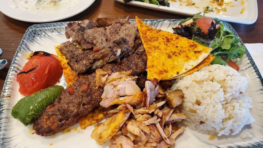 Lamb Gyro · Marinated meat gyro vertically grilled served with rice and house salad.
