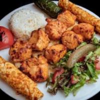 Chicken Shish Kebab · Marinated chicken chunks grilled on skewer served with rice and coleslaw.