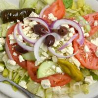 Greek Salad · Lettuce, feta, tomatoes, cucumbers, onions, dolma, peppers and black olives with our home ma...