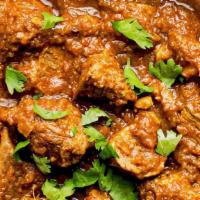 Goat Achaari · Tender Goat meat is cooked in tomato and onion sauce with pickling spices
