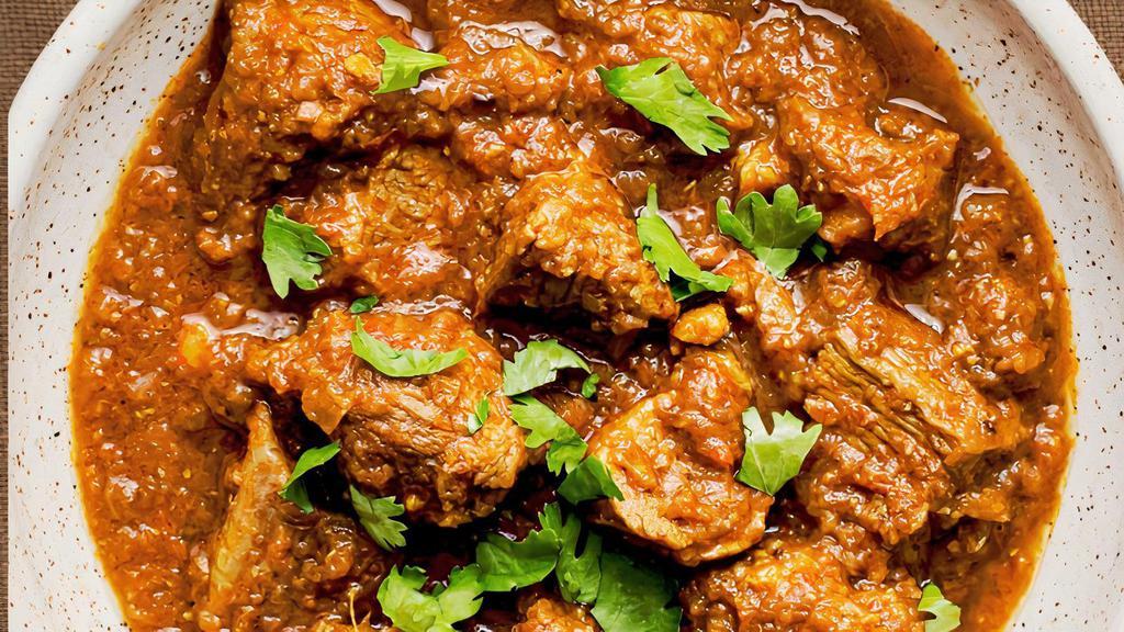 Goat Achaari · Tender Goat meat is cooked in tomato and onion sauce with pickling spices