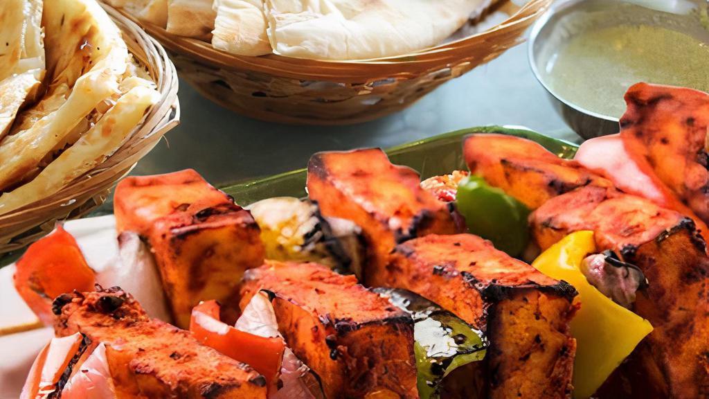 Paneer Tikka · Marinated cubes of cottage cheese grilled with assorted veggies in tandoor to golden brown.