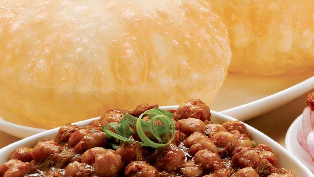 Chole Buture (2Pc.) · Fried All four Bread served with Masala Chickpeas Curry.