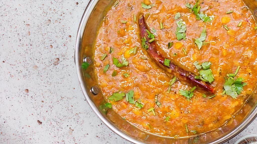 Yellow Dal Tadka · Yellow lentil stew which is seasoned with fried onion, tomato and spices.