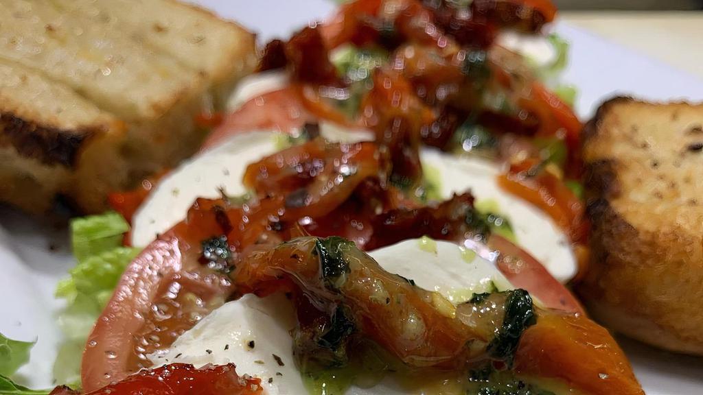 Fresh Mozzarella Platter · Fresh mozzarella, sun dried tomatoes, sliced tomatoes, roasted red peppers and fresh basil with a drizzle of tuscan olive oil. Served with grilled garlic focaccia.