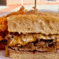 Pirate Rib Eye Steak Sandwich · Thin sliced rib eye is grilled and topped with cheddar, caramelized onions and mushrooms and...
